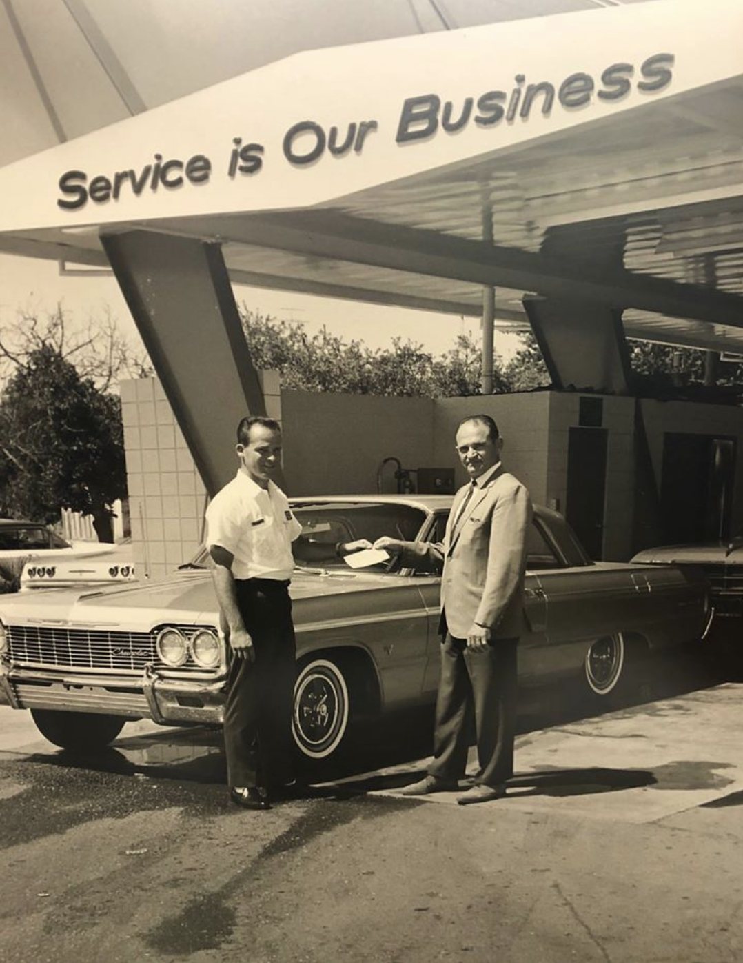 General Manager Jim Waller with a customer who just won a free car in an area raffle. 1965